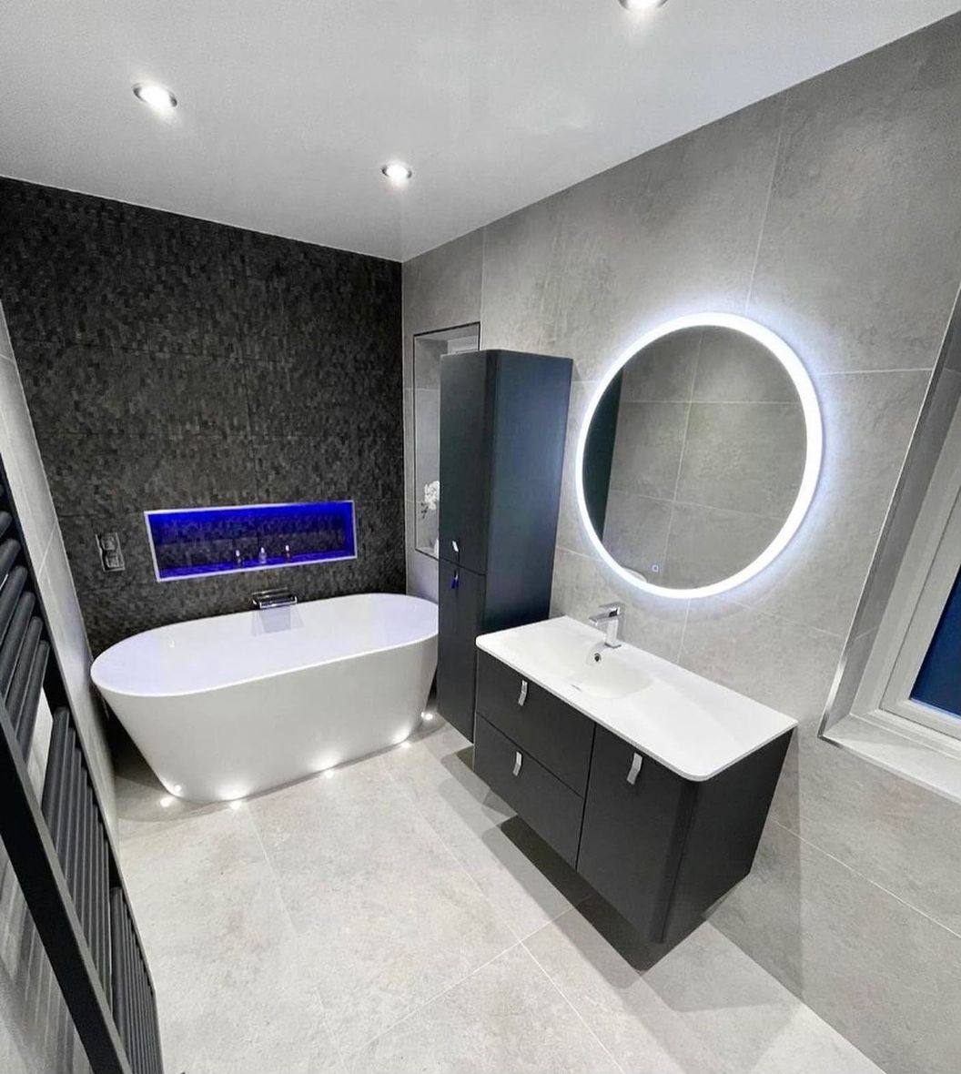Completed bathroom renovation by INNA GROUP — frameless shower and stone tiling.